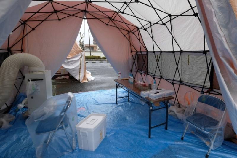 A temporary site for collecting samples for coronavirus testing is setup at a parking lot at Tokyo's Katsushika Ward sport facility on April 20, 2020, which will adopt a method similar to a drive-through allowing people to visit the site by car. (Photo by Kazuhiro NOGI / AFP)