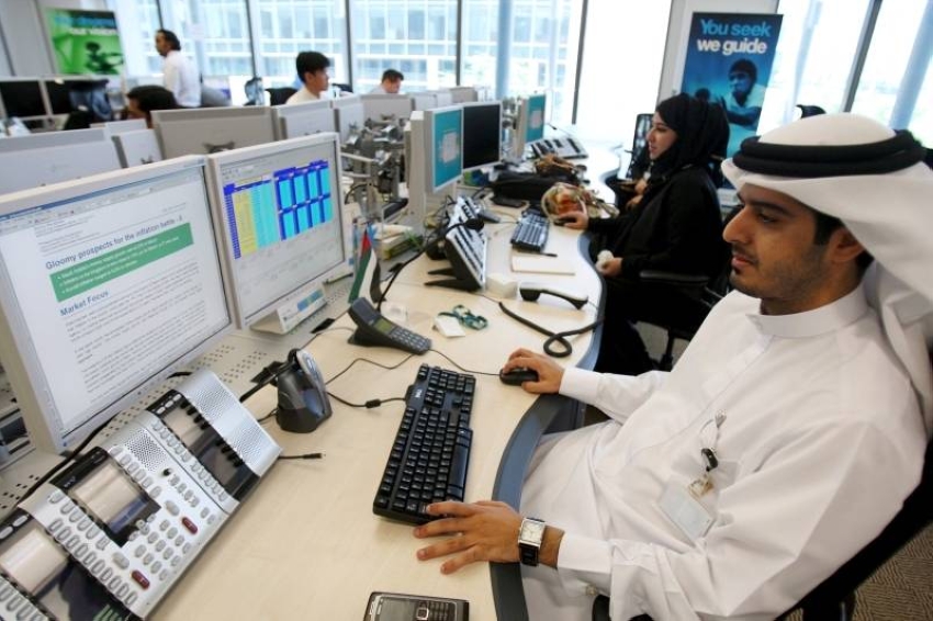 International employees of Standard Chartered work at the new trading room in Dubai International Financial Centre (DIFC) in Dubai